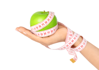 Female hand holding green apple wrapped with measuring tape isolated on transparent background. Weight loss and dieting concept