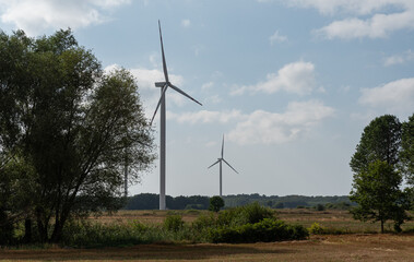 Koszalin, Poland - August 25, 2022: Wind turbines. Green energy from wind. Electricity generating windmills.