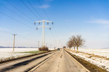 Winter season, view of cars and snowy street through windshield while driving in Bucharest, Romania, 2021.