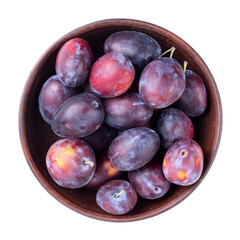 Ripe plums in a bowl isolated on white background. Top view. File contains clipping path.