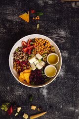 Mediterranean greens, sautéed beets, green olives, sun-dried tomatoes, boiled black-eyed peas, tomatoes, feta cheese, chickpeas, lemon sauce with olive oil bowl 