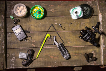 Multifunctional knife with scissors. Scissors and other tools for fishing. Tools on the box. View from above.