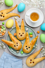 Easter bunny buns from yeast dough on a plate. Traditional Easter dessert rabbits, eggs, symbol,...