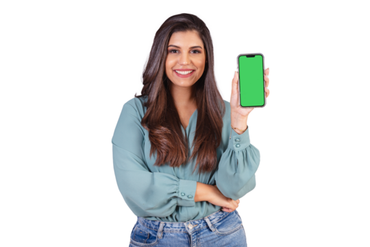 Horizontal photo. Beautiful Brazilian woman, with casual clothes, Jeans and green shirt. showing smartphone with green screen.