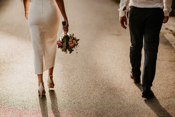 wedding details essentials white wedding dress bride in white robe getting ready for wedding day rings sandals heels sea sunset seaside