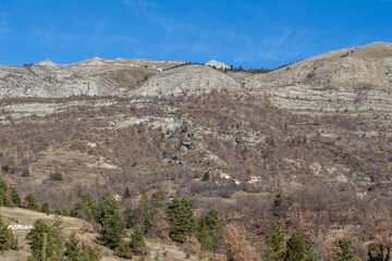 Winter landscape of Ainac-Lambert, a small hamlet of La Robine sur Galabre, near Digne-les-bains in the Alps mountains of the Alpes de Haute Provence, France. Blue Sky.