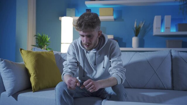 Mentally ill schizophrenic and depressed young man going crazy at home.