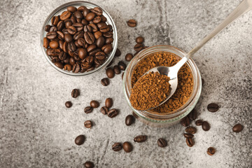 Ingredients for making coffee - coffee beans, ground and instant coffee on a black textured background. Caffeine. Decaffeinated coffee. Aroma energy hot drink. Place for text, space for copy.