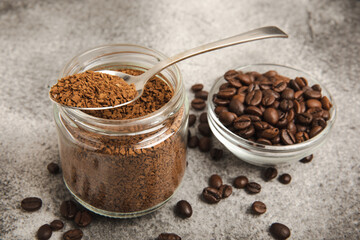 Ingredients for making coffee - coffee beans, ground and instant coffee on a black textured background. Caffeine. Decaffeinated coffee. Aroma energy hot drink. Place for text, space for copy.