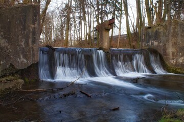 Foamy, rushing water falling from an artificial threshold on the Brzeznica River in Plock.