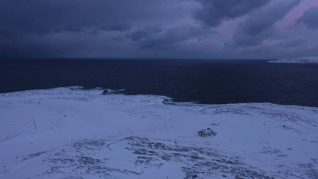Aerial view of dark severe nature of Barents sea coast in winter