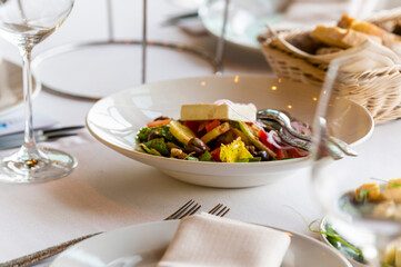 salad with cheese with fresh vegetables on a plate