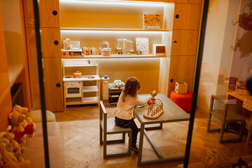 Obraz na płótnie Canvas Toddler child playing in children's corner at room