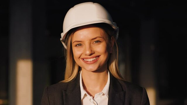 Portrait of Female Building Architect on a City Construction Site. Woman Smiles and Looks into the Camera