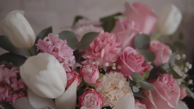 Elegant bouquet of pink roses and other flowers captured in beautiful slow-motion footage. Ideal for a wedding or anniversary celebration.