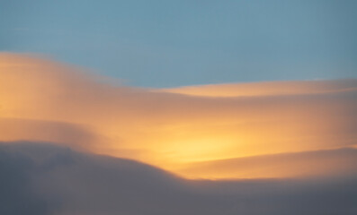Fototapeta premium Beautiful bright orange sunset sky with dramatic clouds. Sunset sky background.