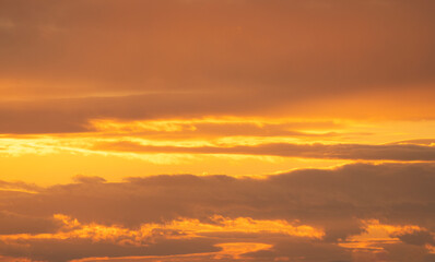 Beautiful bright orange sunset sky with dramatic clouds. Sunset sky background.