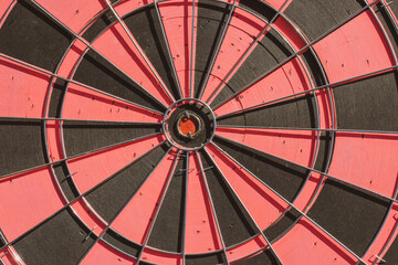 Red black dart wall. Round shape background, wallpaper. Dartboard center ring with the bull eye....