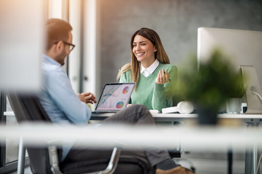 Smiling businessman taking interview of a female job applicant