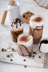 Chocolate frappe in a variety of glasses with chocolate syrup