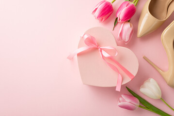 8-march celebration concept. Top view photo of pink heart shaped giftbox with ribbon bow tulips and beige high heel shoes on isolated pastel pink background