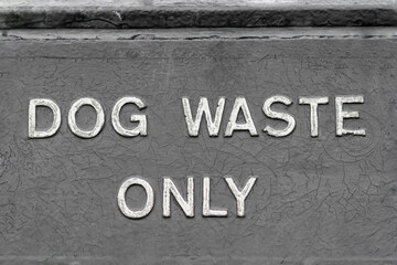 Fototapeta na wymiar Generic and seamless DOG WASTE ONLY grey bin sign.