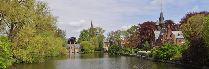 Romantic view of the Minnewater Lake in the historical center of Bruges, West Flanders, Belgium 