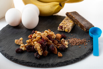 Variety of nuts and dried fruits. Candy from nuts. Preparing a snack from nuts and berries. Protein bars.