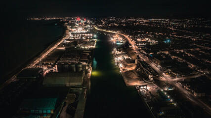 Aerial view of an industrial estate and port with warehouse at night