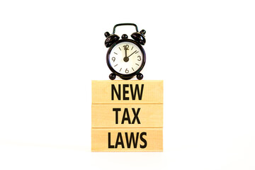 New tax laws symbol. Concept words New tax laws on wooden blocks on a beautiful white table white background. Black alarm clock. Business new tax laws concept. Copy space.