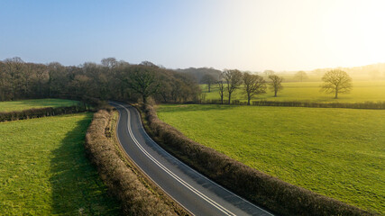Fototapeta na wymiar Aerial view of road and trees in spring colours, West Sussex, UK.