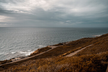 Standing on cliff overlooking looking the ocean on a cloudy day - Pacific Ocean - San Diego Cliffs