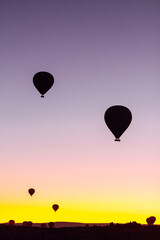 Flying hot air balloons rise in sunrise Cappadocia. Goreme National Park Turkey.