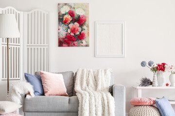 Interior of living room with sofa and flowers in vases