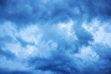 Light in the dark and dramatic storm clouds. Stormy clouds in the dark sky.