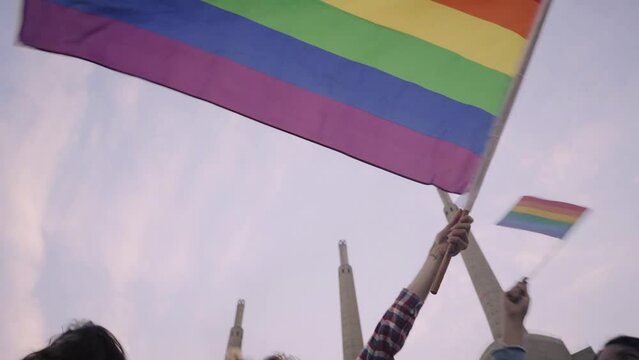 People celebrating Gay Pride waving Rainbow Flags. High quality FullHD footage