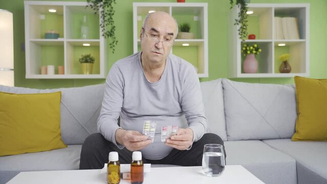 A senile old man taking medicine by heart.
The grumpy, senile man using over-the-counter drugs.
