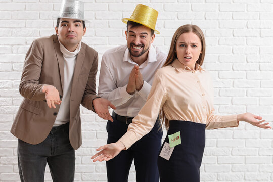 Office prank and workplace humor, colleagues playing a practical joke on a woman with sticky notes on her back