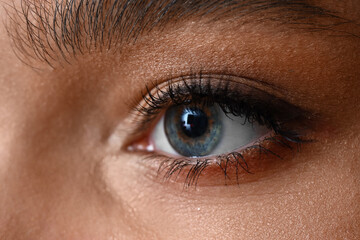 Fototapeta na wymiar Young woman with blue eyes, closeup