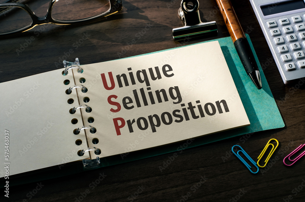 Poster there is a notebook with the word unique selling proposition. it is an eye-catching image.