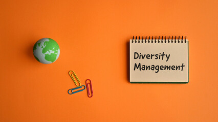 There is a notebook with the word Diversity Management. It is eye-catching image.