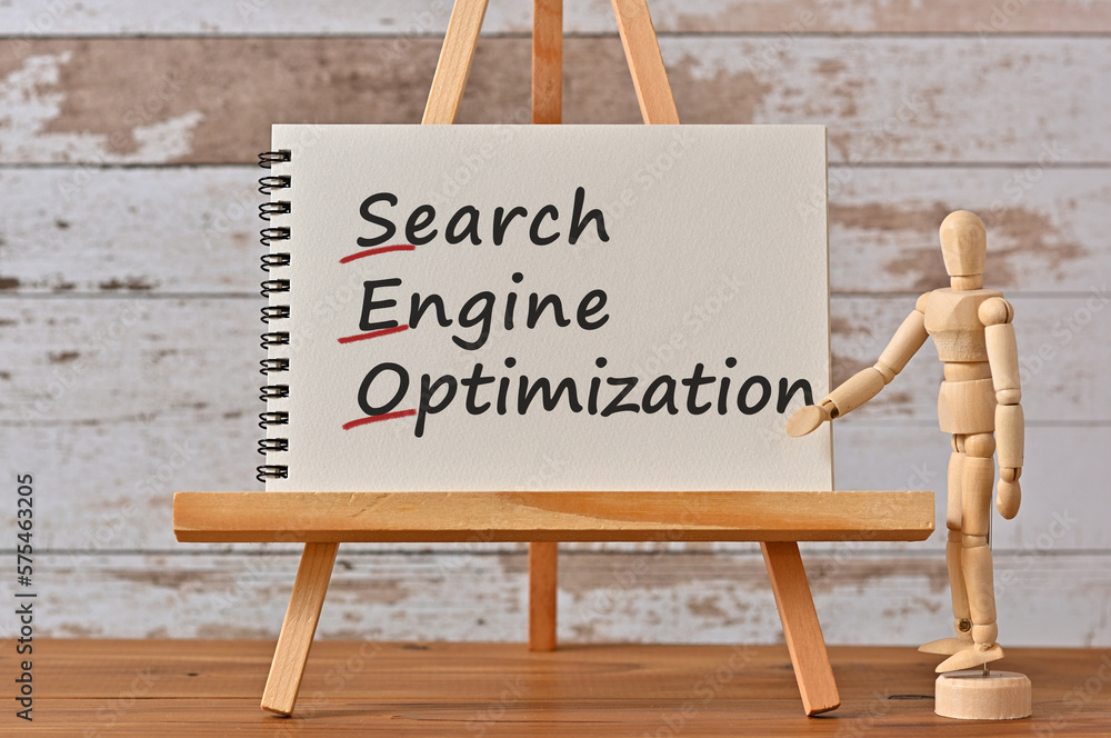 Poster there is notebook with the word search engine optimization. it is an eye-catching image.