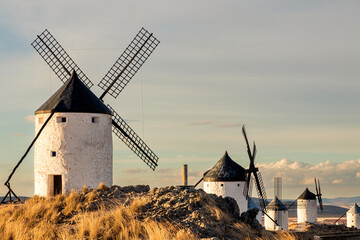 Traditional windmill on a mountain at sunset of Consuegra, Toledo province, Castilla la Mancha, Spain - obrazy, fototapety, plakaty