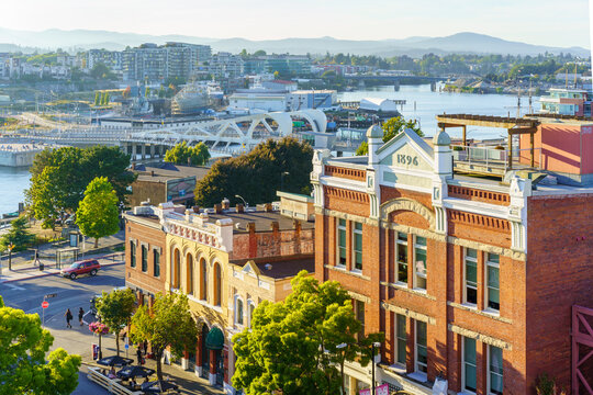 Victoria, British Columbia, Canada - September 6, 2020: Tourists are visiting a historic street that includes the Leiser Building, nearby Johnson street bridge and busy shipyards 