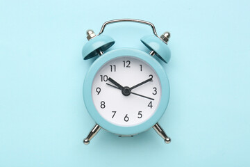 Alarm clock on blue background