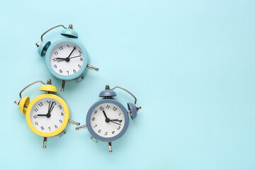 Obraz na płótnie Canvas Alarm clocks on blue background