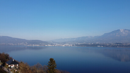 Fototapeta na wymiar View over a lake. Blue sky and mountain.
