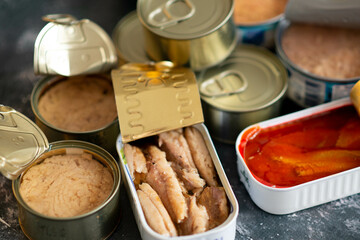 Three varieties of sardine cans, with tomato and with olive and sunflower oil