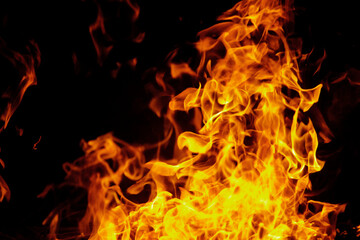 Fototapeta na wymiar Close up burning flames on black background for graphic design or wallpaper
