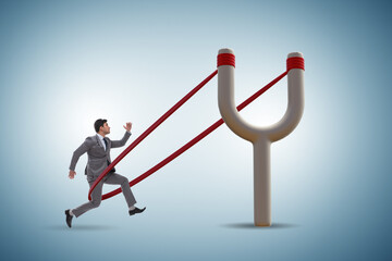 Businessman being launched from slingshot in career concept